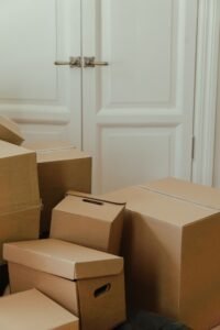 Services Cardboard boxes stacked in an apartment, signifying a move-in or relocation process.